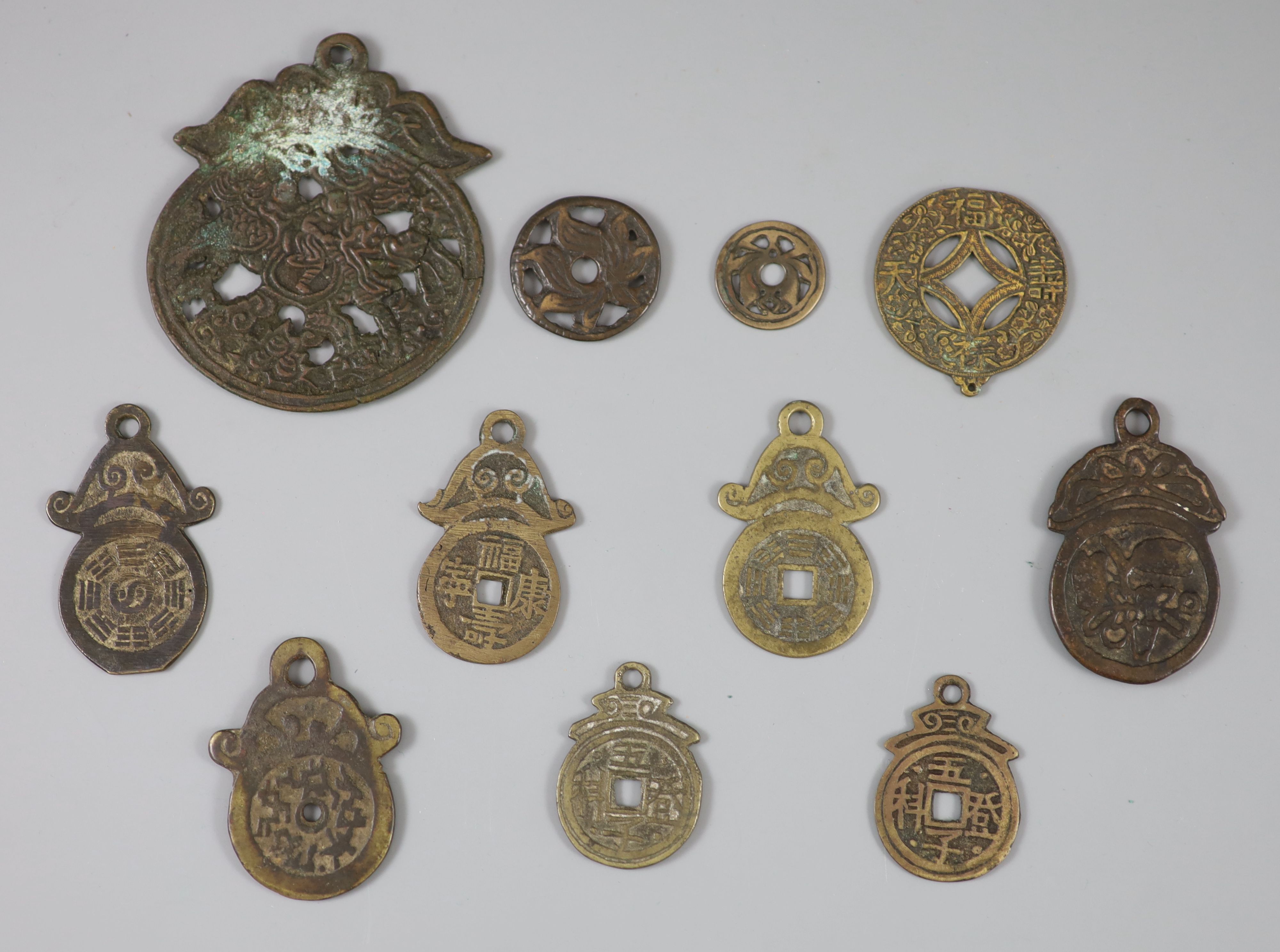 China, 11 bronze charms or amulets, Qing dynasty or earlier,